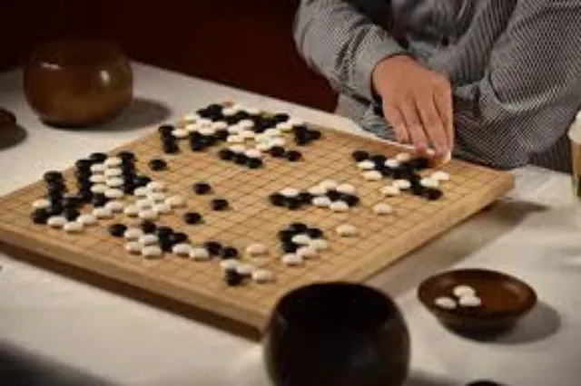A Go board with black and white stones placed during a game
