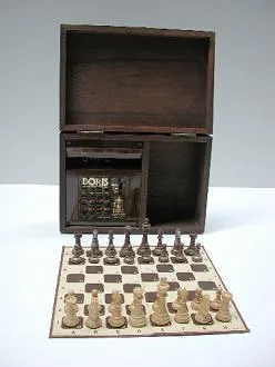 Handheld dedicated chess computer with a small board and chess pieces on its surface
