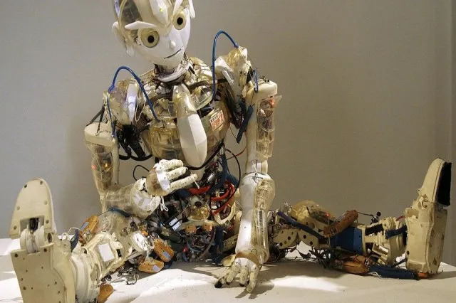 Humanoid robot performing a physical task, with a schematic of a neural network alongside