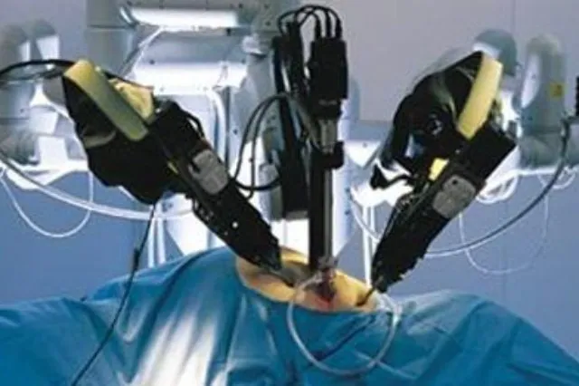 Robotic arm system mounted over an operating table in a surgical suite