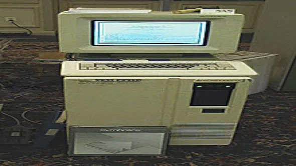 A Lisp Machine workstation with a monitor, keyboard, and large rectangular hardware unit on a desk