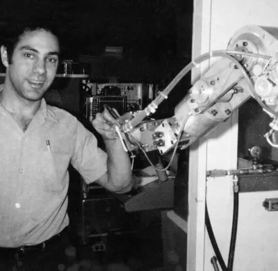 Six-axis robotic arm mounted on a base, showing multiple revolute joints