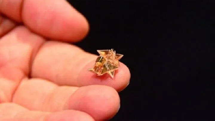 Microscope image of a microscale folded robot structure, roughly 100 to 250 microns in size