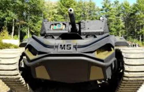 Low-profile tracked unmanned ground vehicle on an outdoor surface