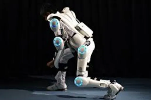 Person wearing a powered lower-limb exoskeleton frame while standing upright