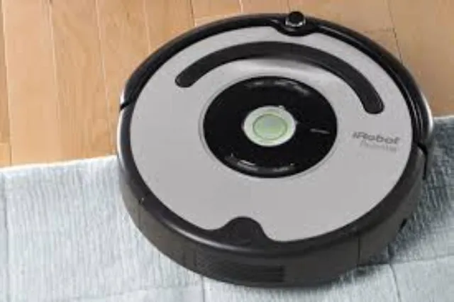 Circular disc-shaped robotic vacuum cleaner on a floor