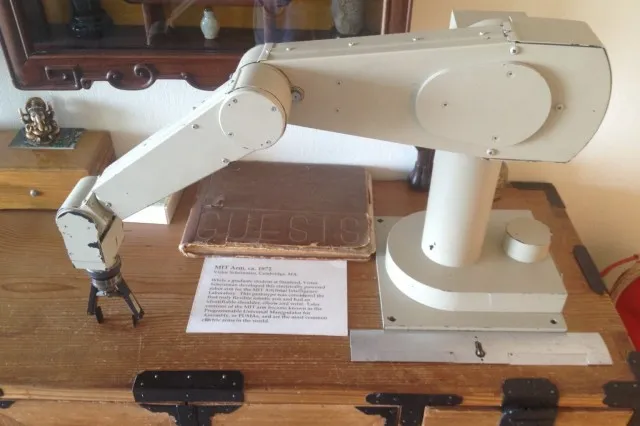 Six-axis robotic arm mounted on a base, with slender jointed segments