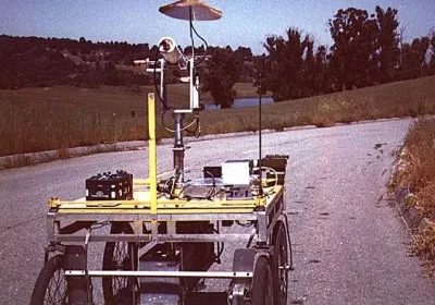 Four-wheeled cart on an outdoor road, with a camera mounted on its frame