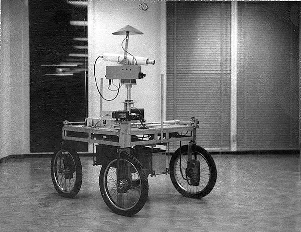 Four-wheeled cart with a horizontal sliding camera mount extending across its frame