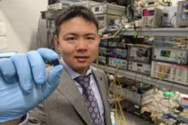 Researchers working with optical laboratory equipment and a photonic chip setup on a workbench