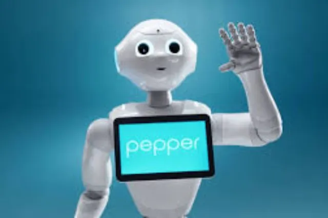 A white humanoid robot standing at roughly chest height, with a tablet screen on its torso